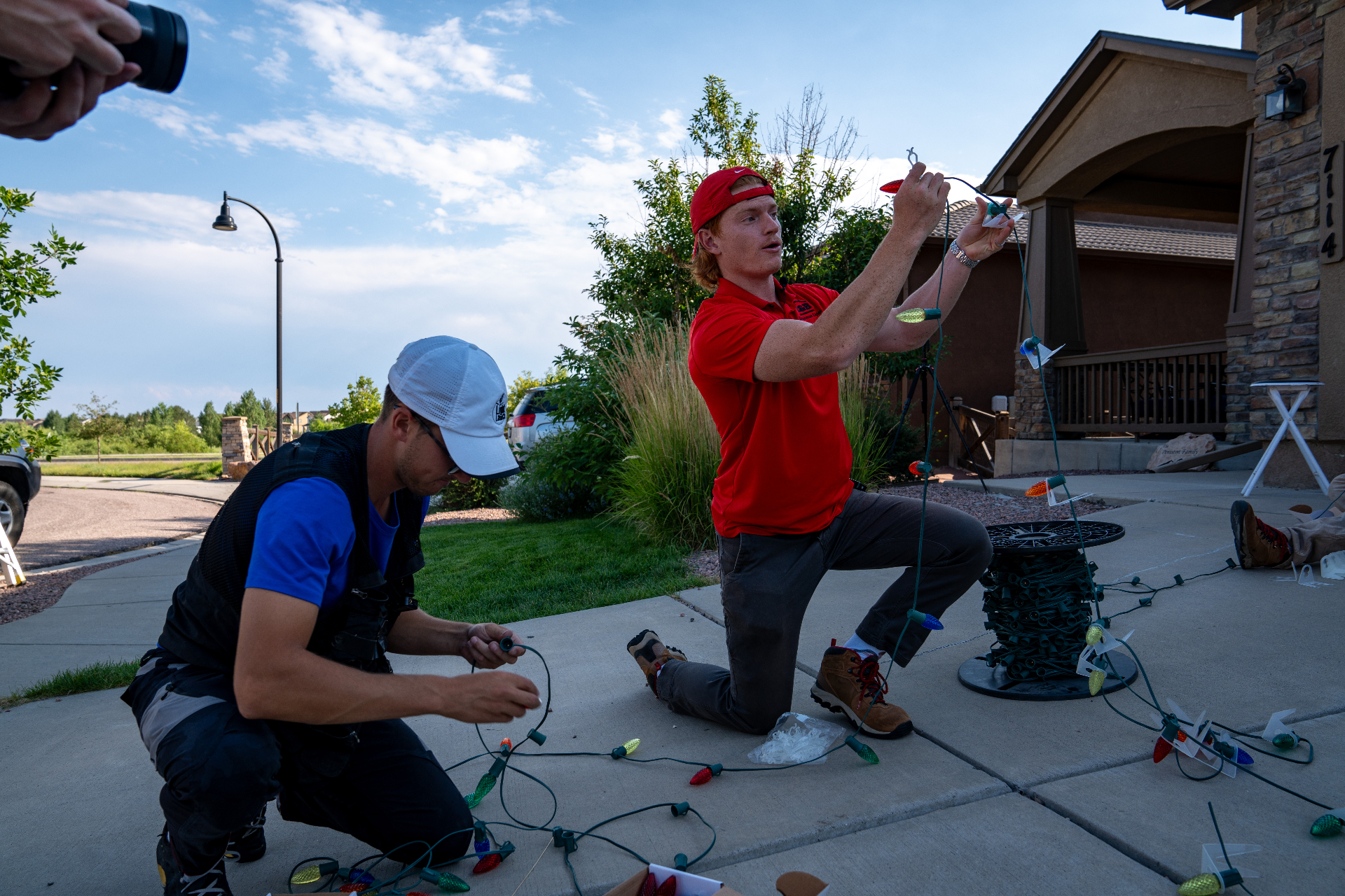 Christmas City Holiday Lighting crew installing permanent outdoor lighting on a home